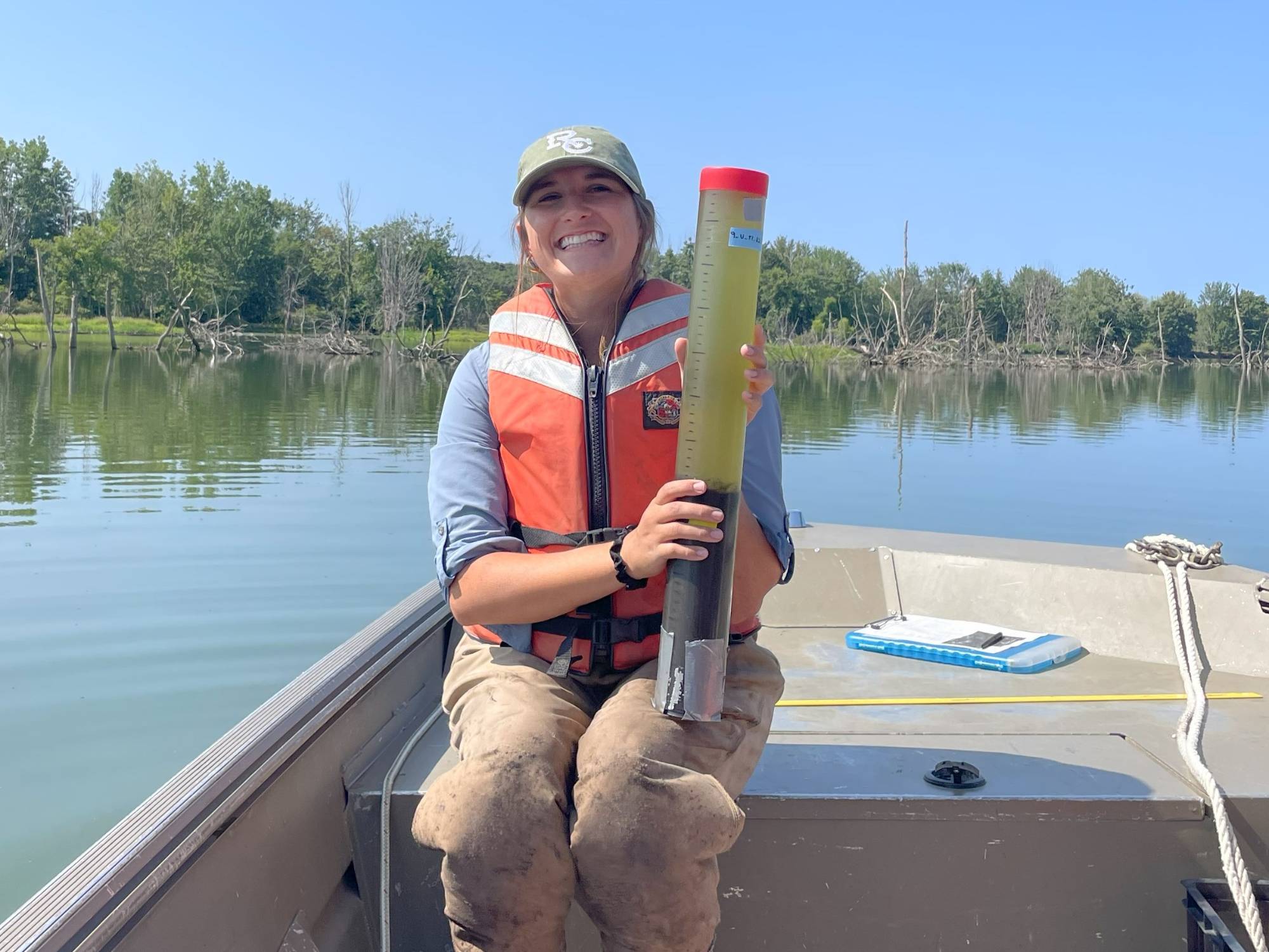 Kate Lucas holds a sediment core.